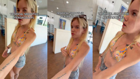A young woman wearing a bikini top and shorts, with visible tattoos, stands at the counter of a Tropical Smoothie Cafe in Florida, arguing with a female employee who is refusing to hand over a smoothie that is already made and sitting on the counter behind her.