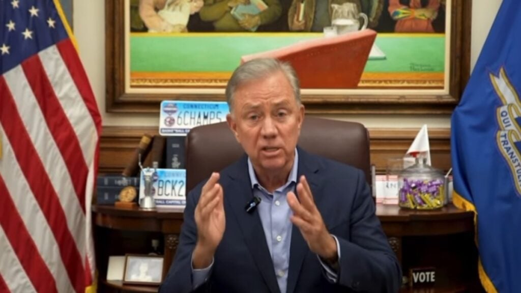 Connecticut Gov. Ned Lamont signed a bill into law restricting ICE agents from wearing masks to hide their identities and barring warrantless entries into sensitive areas. The X post by @greg_price11 showing the ceremony has exploded with reactions.