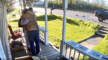 Matthew Rutkowski embraces his son Jeremiah outside their home in Bouckville, New York, after a distracted pickup truck driver slammed into the back of Jeremiah's school bus on Route 20 in Madison County on May 7, 2026.