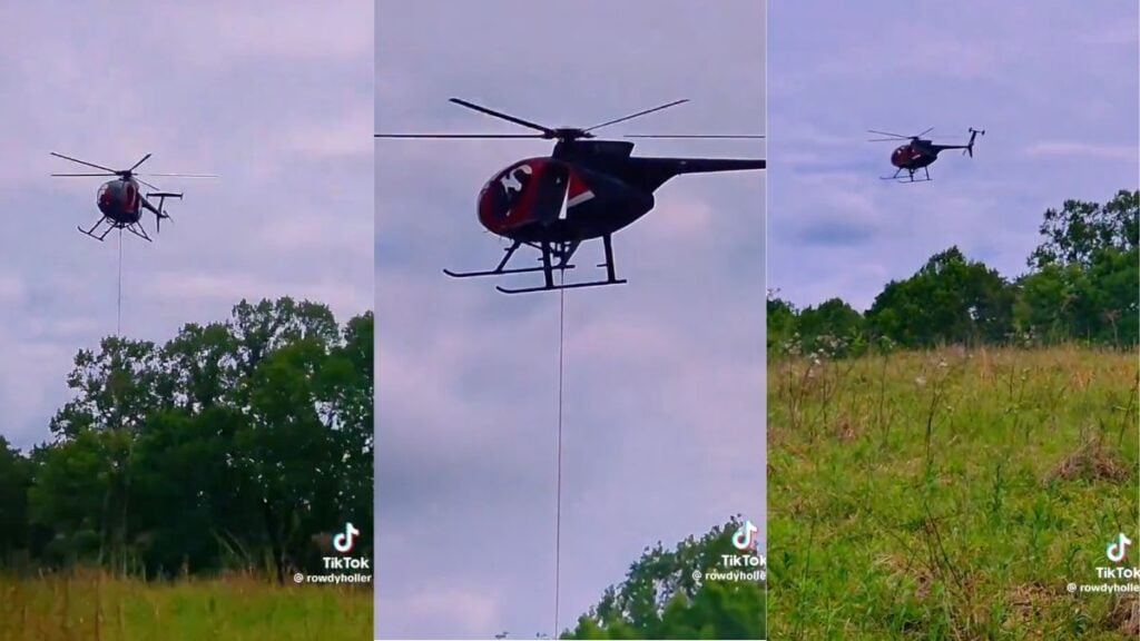 Kentucky Farmer Films Helicopter Hovering Over Her Private Land for Alleged Data Center Plans: ‘What Are Y’all Even Doin’?’ A black-and-red helicopter linked to the Department of Interior fleet flies low over a green Appalachian field in Kentucky, towing a long cable with a weighted sensor or probe at the end, as a landowner films from the ground below during a second pass over their private homestead farmland.