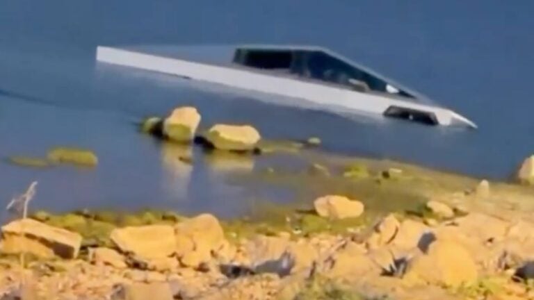 Texas Man Sinks His Cybertruck In A Lake Testing ‘Wade Mode,’ Gets Arrested: ‘What Has The World Come To’ A Tesla Cybertruck partially submerged near the shoreline of Grapevine Lake at Katie's Woods Park Boat Ramp in Grapevine, Texas, following an incident on May 19, 2026 in which the driver intentionally drove into the lake to test the vehicle's Wade Mode feature.