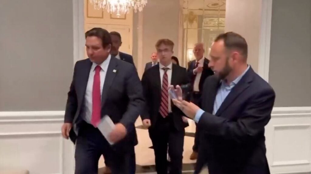 Florida Gov. Ron DeSantis Makes Quick Exit After Question About Trump’s $1.776 Billion Fund: ‘He Literally Can’t Run Faster’ Florida Governor Ron DeSantis walks briskly through a hallway and up a staircase while reporters shout questions in the background.