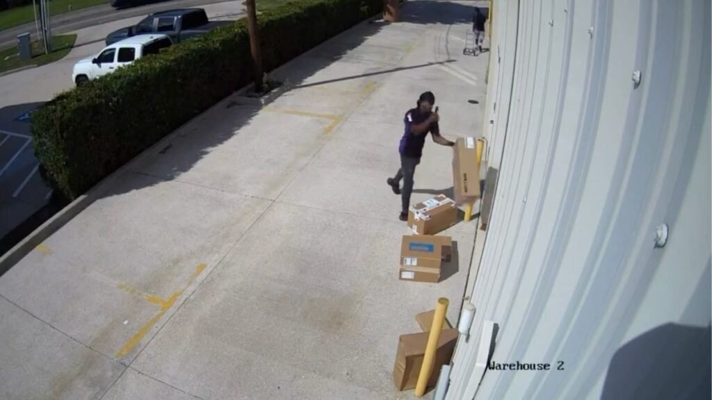 Security camera footage from a Texas warehouse loading dock shows a FedEx worker in a dark shirt repeatedly dropping, slamming, and kicking boxes containing approximately $20,000 worth of Lutron equipment on May 26, 2026, while a second worker handles deliveries nearby.