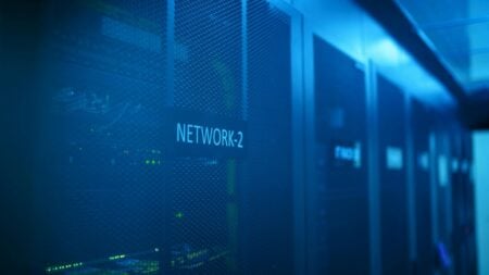 New Jersey Township Enacts Full Data Center Ban After Community Pushback: ‘They Need To Be Banned Everywhere’ A modern server room featuring network equipment with blue illumination.