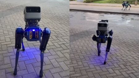 A Boston Dynamics Spot quadruped robot with Hyundai branding standing near a large stadium venue.