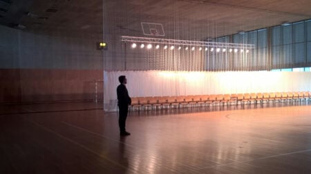 Student Standing in a Basketball Court
