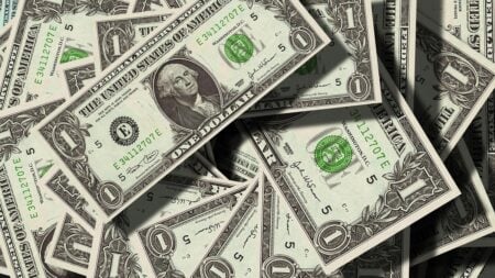 Dollar bills on top of each other.