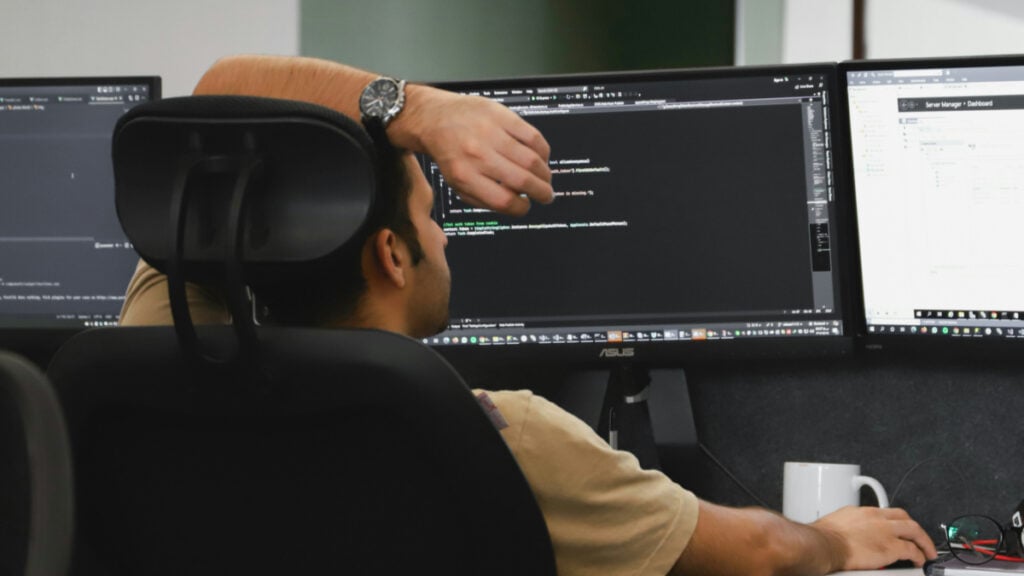 ‘AI-Generated Art Cannot Be Copyrighted’: Texas Video Game Artist Defends Using AI After Allegedly Getting Another Developer Suspended Developer Sitting at Desk with Multiple Monitors