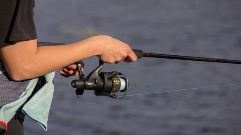 ‘Wait, She’s Actually Funny’: Florida Karen Confronts Fisherman Over Alleged Trespassing Drama Person holding a fishing rod and reel while standing near a body of water