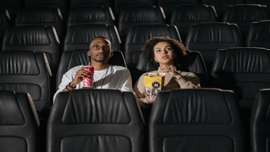 Georgia Couple Says Movie Theater Singled Them Out After Confrontation Over Phone Use: ‘We Were the Only Black People There’ Couple sitting in a movie theater during a screening