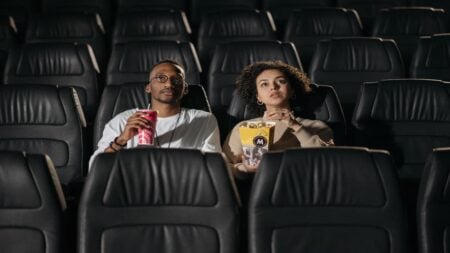 Georgia Couple Says Movie Theater Singled Them Out After Confrontation Over Phone Use: ‘We Were the Only Black People There’ Couple sitting in a movie theater during a screening