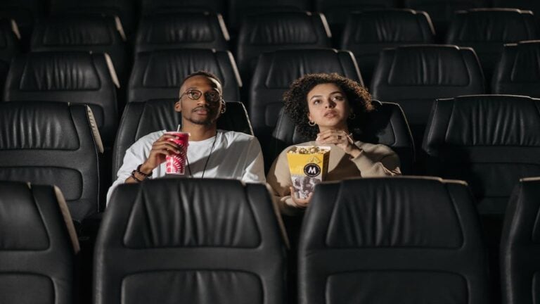 Georgia Couple Says Movie Theater Singled Them Out After Confrontation Over Phone Use: ‘We Were the Only Black People There’ Couple sitting in a movie theater during a screening