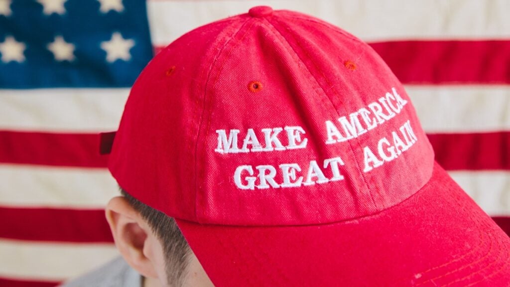 Outrage After Texas GOP Convention Told Muslims to Leave: ‘They’re not really a Conservative Party anymore’ A white man wearing a MAGA hat in front of the USA flag