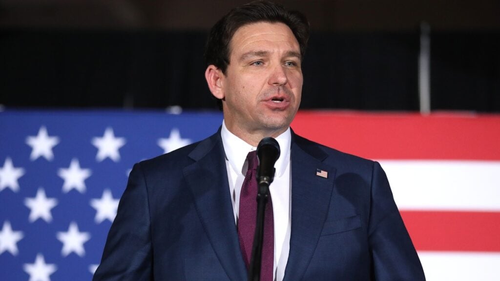 Florida Republicans Slammed as 39% of Families Use ‘Buy Now, Pay Later’ Services for Groceries: ‘What Kind of Society Do We Live In?’ Picture of Ron DeSantis in front ot the USA's flag.