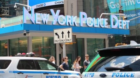 New York Police Officer Loses Composure, Tries to Fight Civilian Before Being Restrained: ‘You Can’t Allow Your Emotions to Get You’ NYPD cars and people in front of New York Police Department building in Times Square.