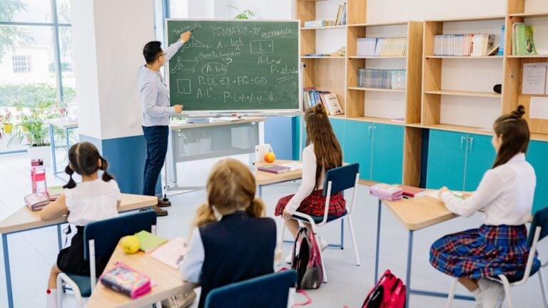 A school with a man teaching children.