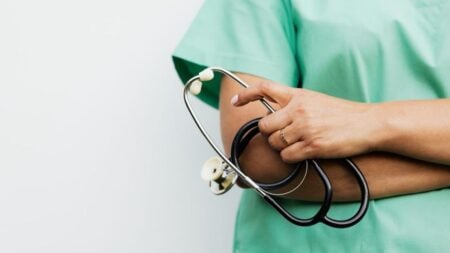 Texas Woman in Scrubs Confronts Muslim Shoppers at H-E-B: ‘Go Back to Your Islamic Country’ Close-up of a healthcare worker holding a stethoscope, showcasing medical professionalism.