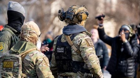 Federal agents ram a man's vehicle and demand identification at Park Avenue and 35th Street in Minneapolis on January 12, 2026.