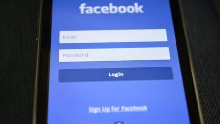 Close-up of a smartphone screen showing the Facebook login interface.