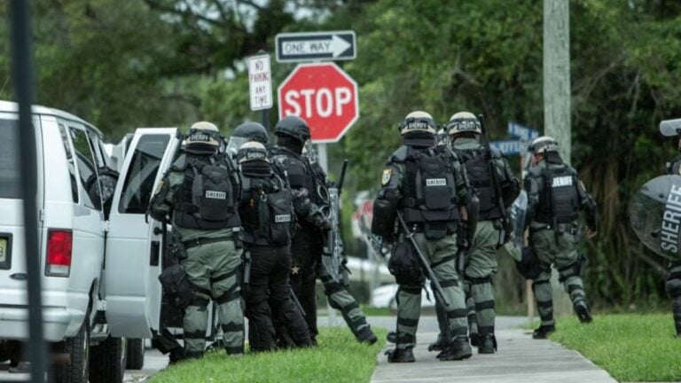 Police tactical unit in action during operation on a street in Brooksville, FL.