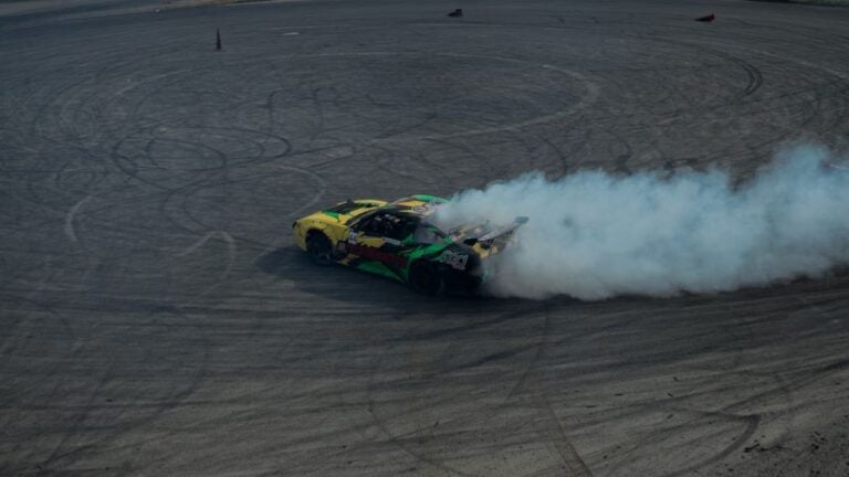Dynamic drifting car creating smoke on track in Istanbul. Perfect for motorsport themes.