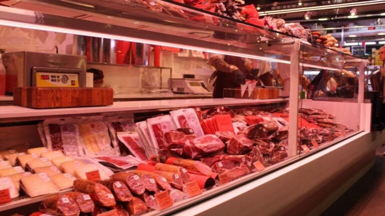 Internet Furious After Washington DC Couple Climbs Into Supermarket Meat Freezer And Lies On Packaged Meat: ‘Pay For All The Food They Just Contaminated’ Fresh meat selection in a Barcelona market deli, vibrant display and diverse cuts.