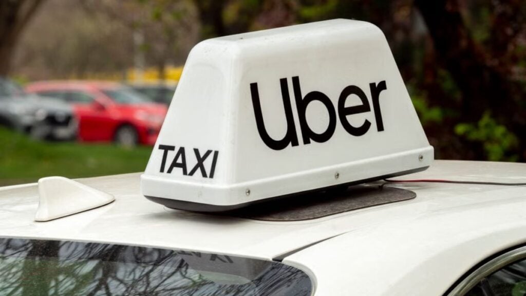 Texas Uber Driver Refuses To Drive Woman Away After She Allegedly Steals Case Of Vodka: ‘Iconic Refusal Energy’ Close-up of a white Uber taxi sign on a car roof in Wrocław, Poland.