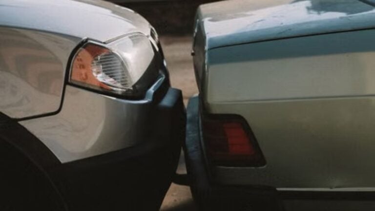 Illinois Woman Hits Another Car From Behind, Then Plays the Victim During Emotional Outburst: ‘You Hit Me’ A close-up view showing the aftermath of a rear-end car collision in an outdoor setting.