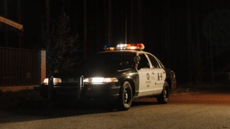 Police Car Sitting on the Street at Night