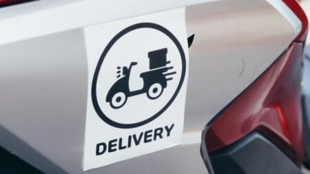 19-Year-Old DoorDash Driver Delivers Order to Wrong Indiana House, Homeowners Refuse to Give It Back: ‘What a Bunch of Childish, Immature Adults’ A delivery sticker featuring a scooter on a motorcycle's metallic surface.