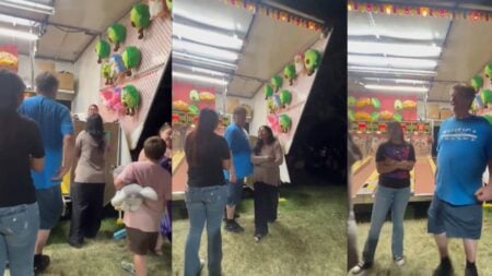 Group of people arguing near a carnival skee-ball game booth at night.