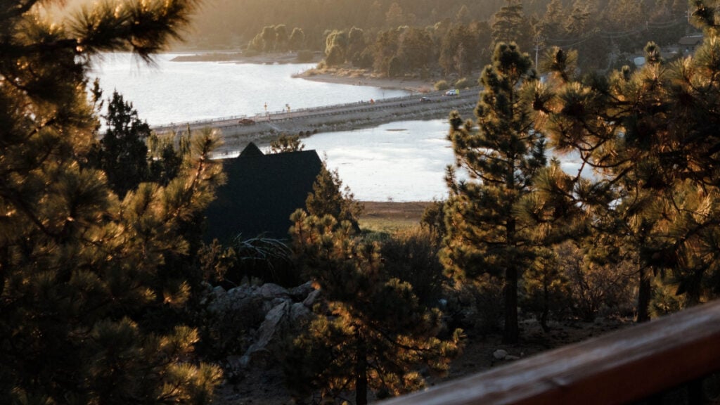 Wisconsin Boss Called Out for Sharing Vacation Updates With Employees Who Can’t Afford the Trip: ‘It’s Tone-Deaf and Weird’ scenic mountain lake at sunrise with pines