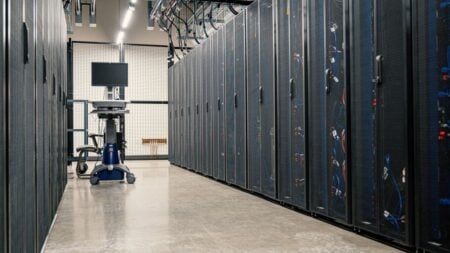 New Mexico Woman Knocked to the Ground and Arrested at Data Center Protest Meeting: ‘They Are All Getting Paid Behind Closed Doors’ Modern data center corridor with server racks and computer equipment. Ideal for technology and IT concepts.
