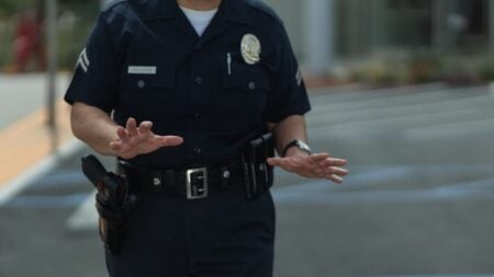 South Carolina Reserve Deputy Fired After Aggressive Confrontation Goes Viral: ‘Wonderful Impulse Control From An Officer’ A police officer in uniform making gestures outdoors in a parking lot.