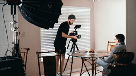 ‘This Sounds Very Illegal’: Illinois Tenant Says Landlord Signed $1,000 Deal to Let Movie Crew Film in Their Home Cameraman setting up Canon camera indoors for video production filming scene