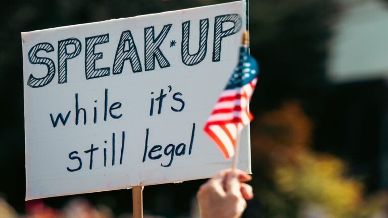 A sign that says "Speak up while it's still legal"