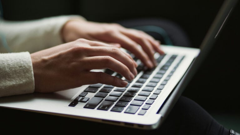 California Woman Says Conservative College Keeps Addressing Her as Her Husband’s Wife: ‘Because He’s Male and I’m Female. Gross’ woman typing on a laptop