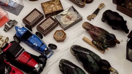 Texas Man’s $14,000 Storage Unit Gets Auctioned for $420 After Autopay Glitch: ‘ABSOLUTE Criminal Disaster’ collection of vintage items and figurines showcased on a white table