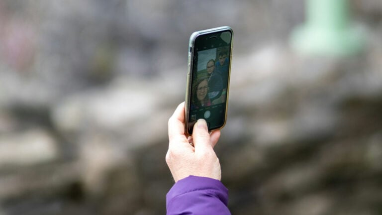 Woman taking a selfie out in a forested area