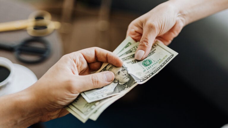 A $6,000 Raise Became Only $47 More Per Paycheck, So Where Did the Money Go? People handing each other dollar bills