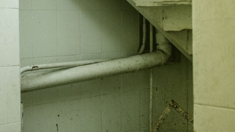 ‘Wait a Minute, I Was in This Exact Basement’: Ohio Homebuyer Says Plumber Exposed Seller’s $18K Secret A neglected stairwell with peeling paint and dim lighting