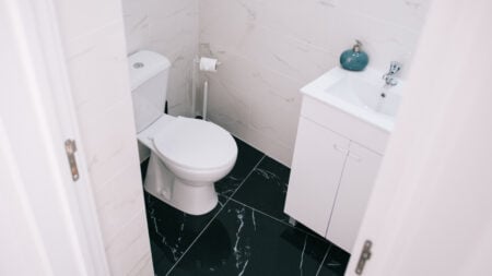 ‘It’s $0.30 a Day for Her to Use It’: Colorado Renter Says Landlord Is Charging Girlfriend to Use the Bathroom A contemporary bathroom showcasing a clean design with marble tiles and modern fixtures
