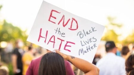 California Man Hurls Racial Slurs at Black Woman Over Parking Dispute, Says She Belongs in a ‘Zoo’: ‘It’s a Hate Crime’ A protester holds a sign reading 'End the Hate' with 'Black Lives Matter' during a rally.