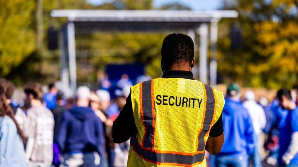 New York Man Returns $500 Target Haul After Security Chases Him Outside Over Receipt: ‘You Don’t Shop Where People Disrespect You’ A security guard monitors a crowd at an outdoor event.