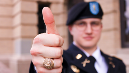 Military officer wearing uniform giving thumbs up gesture