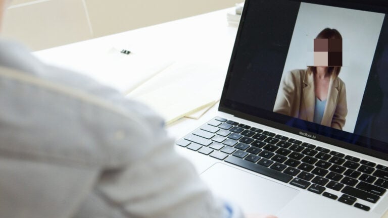 ‘Why Is This Even Legal?’: Pennsylvania Job Seeker Goes Through 4 Interviews for ‘Remote US’ Position, Then Company Rejects Them Over Location Close-up of a person on a video call using a laptop in a modern workspace