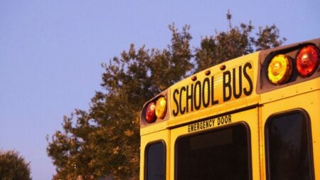 Nostalgic view of a yellow school bus parked outdoors during sunset