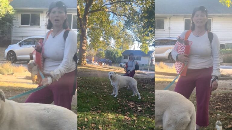 Woman holding dog leash and wine bottle.