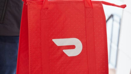 People handing over a doordash bag