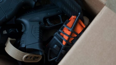 ‘That’s a Serious Felony, Mom’: Georgia Son Says Mother Stole His Firearms During Parents’ Divorce A close-up view of firearms and tactical gear packed inside a cardboard box